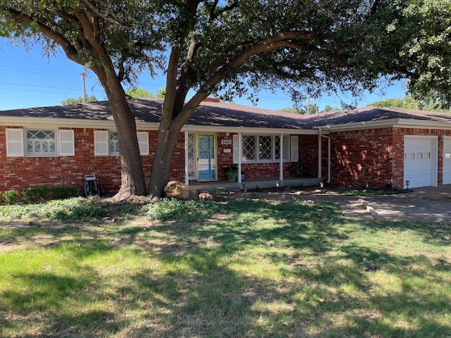 ranch-style house featuring a garage and a front yard