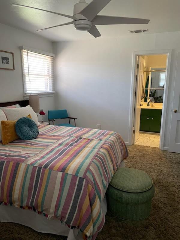 carpeted bedroom with ceiling fan and connected bathroom