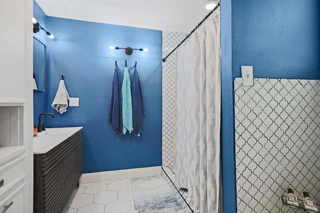 bathroom with a shower with shower curtain, vanity, and tile patterned flooring