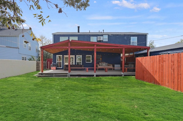 back of house featuring a wooden deck and a yard