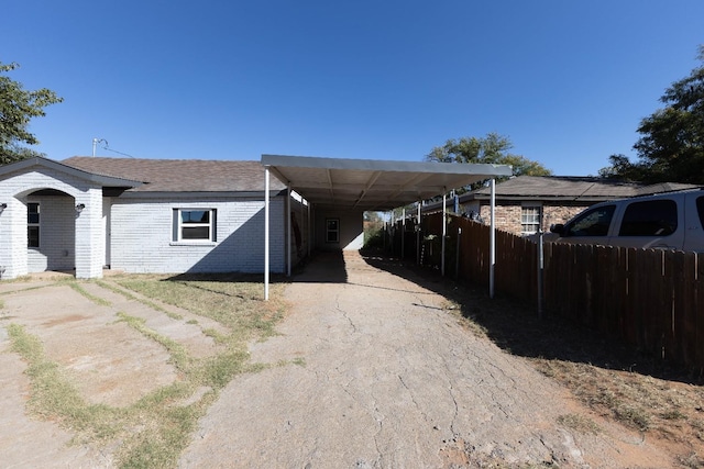 view of side of property featuring a carport