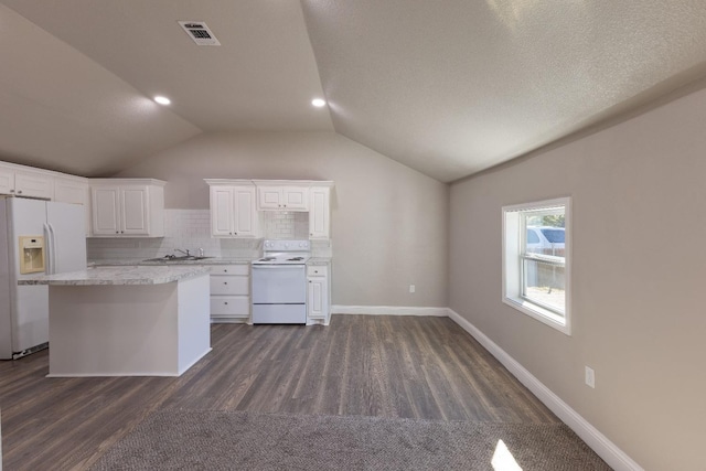 kitchen with white appliances, white cabinets, dark hardwood / wood-style flooring, decorative backsplash, and vaulted ceiling