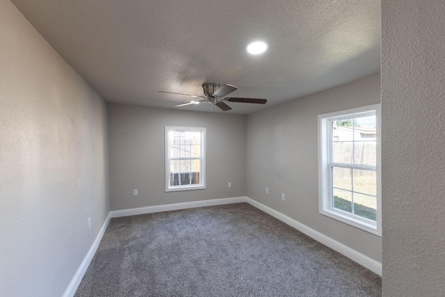 unfurnished room featuring ceiling fan, carpet, and a textured ceiling