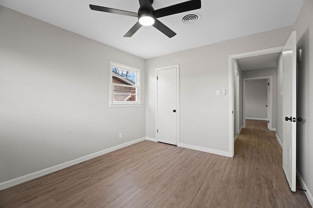 unfurnished bedroom featuring hardwood / wood-style flooring and ceiling fan