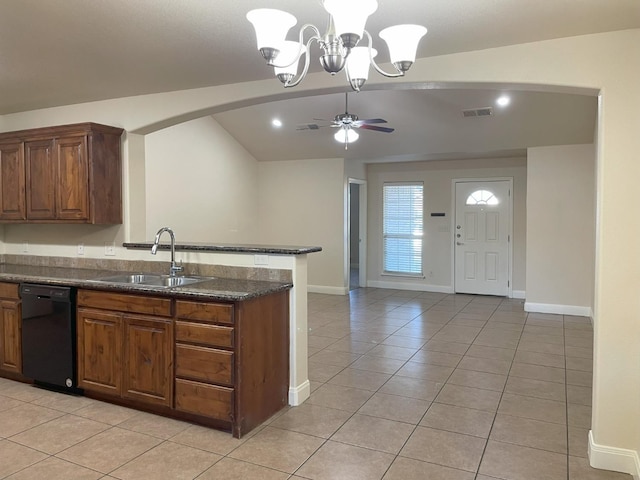 kitchen with light tile patterned flooring, sink, decorative light fixtures, vaulted ceiling, and dishwasher