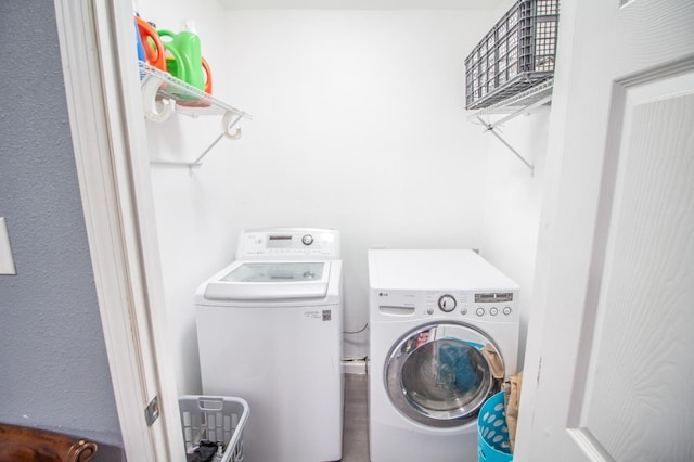 washroom with washing machine and clothes dryer