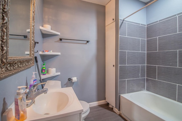 full bathroom featuring vanity, toilet, tiled shower / bath combo, and hardwood / wood-style floors