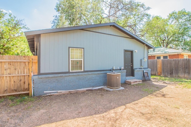 back of house featuring central AC unit