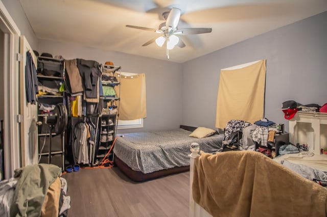 bedroom with ceiling fan and wood-type flooring