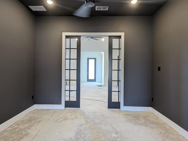 unfurnished room with ceiling fan, visible vents, baseboards, and french doors