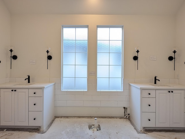 bathroom with two vanities and a sink