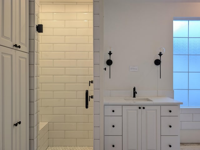 bathroom featuring a shower stall and vanity