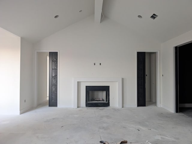 unfurnished living room with high vaulted ceiling