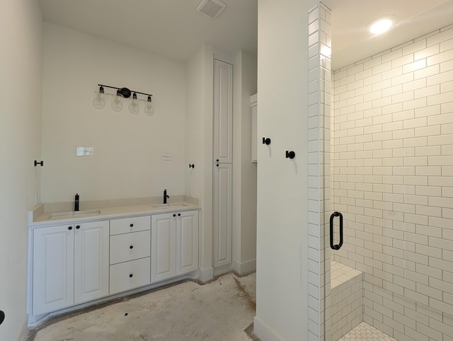 bathroom featuring a stall shower, visible vents, and a sink