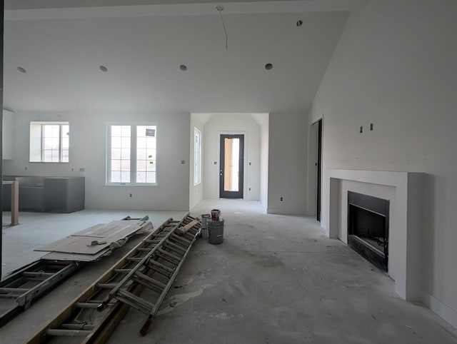 unfurnished living room with a towering ceiling