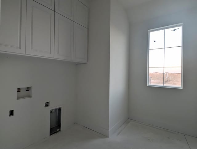 laundry area featuring electric dryer hookup, hookup for a washing machine, and cabinets