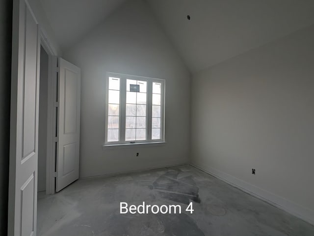 unfurnished bedroom featuring high vaulted ceiling