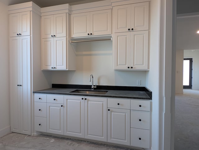 kitchen featuring a sink and white cabinetry