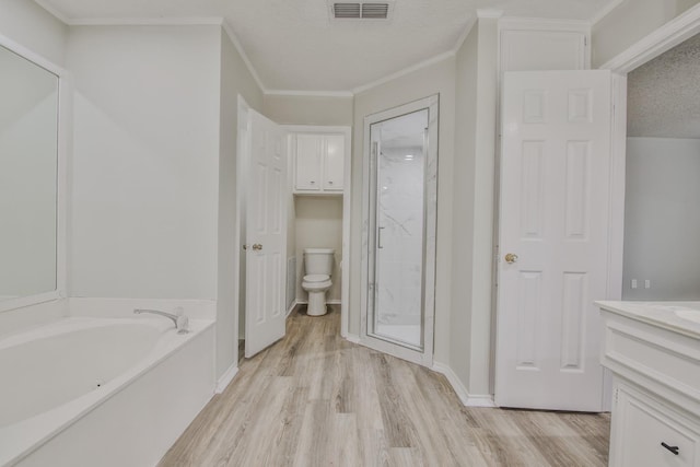 full bathroom with hardwood / wood-style floors, vanity, a textured ceiling, shower with separate bathtub, and toilet