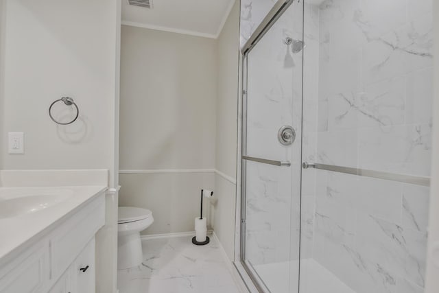 bathroom with crown molding, a shower with shower door, vanity, and toilet