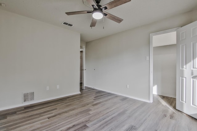 spare room featuring ceiling fan and light wood-type flooring