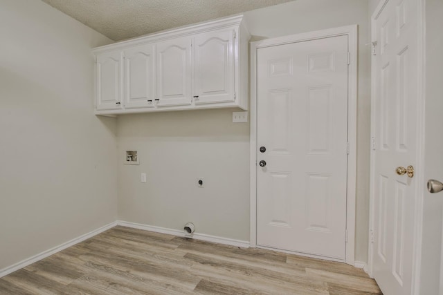 washroom featuring cabinets, a textured ceiling, hookup for a washing machine, electric dryer hookup, and light hardwood / wood-style floors