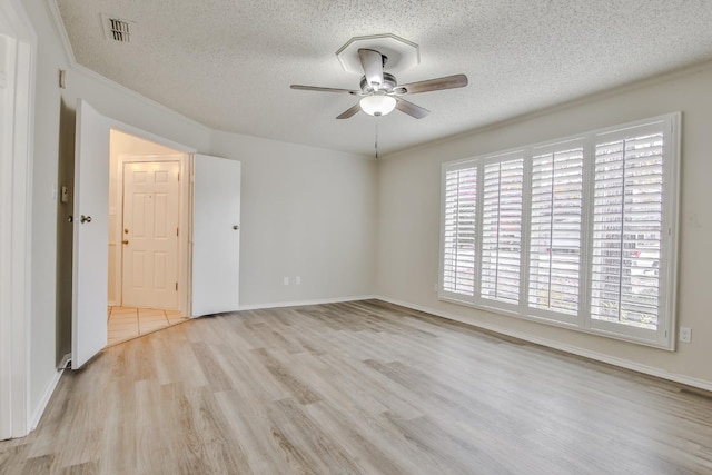 unfurnished room with ceiling fan, light hardwood / wood-style flooring, and a textured ceiling