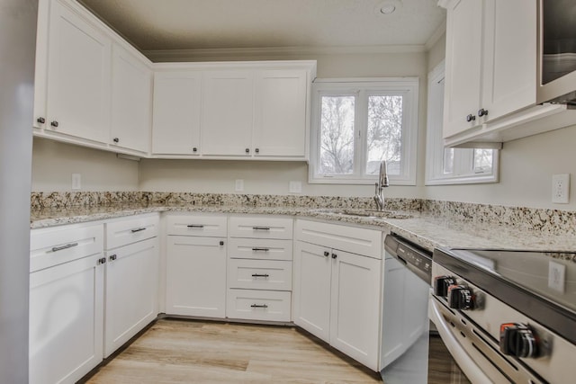 kitchen featuring white cabinetry, light stone countertops, stainless steel appliances, and sink