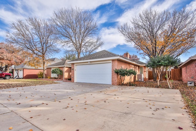 view of property exterior with a garage and central AC unit