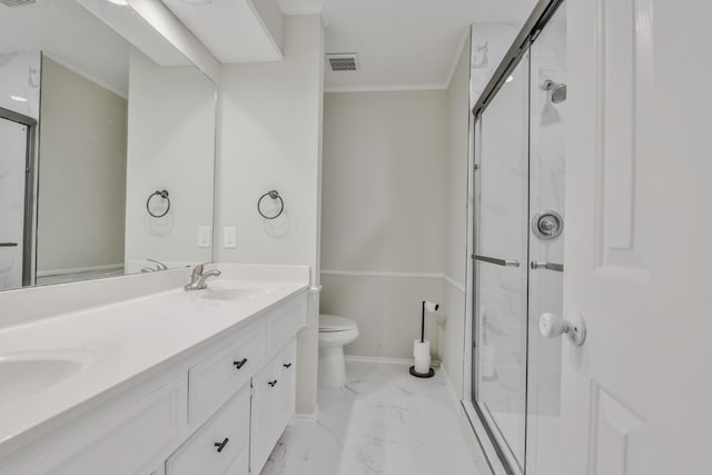 bathroom with vanity, ornamental molding, a shower with door, and toilet