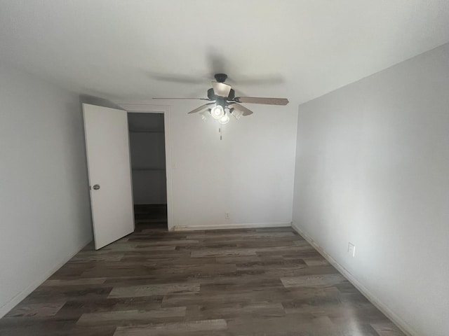 unfurnished room with ceiling fan and dark hardwood / wood-style flooring