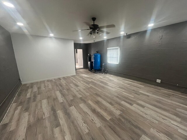 empty room with hardwood / wood-style floors and ceiling fan