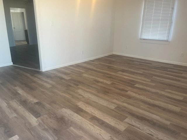 spare room with dark hardwood / wood-style flooring