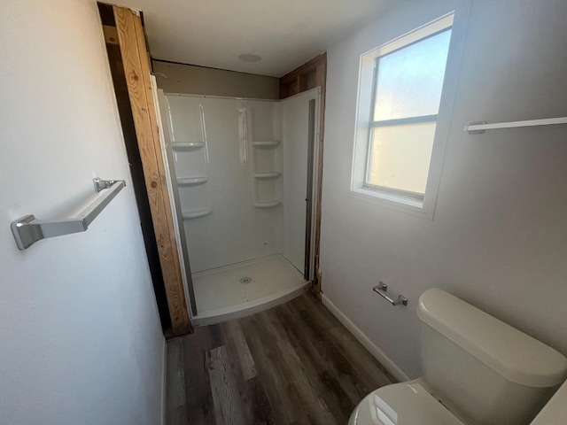 bathroom with walk in shower, wood-type flooring, and toilet