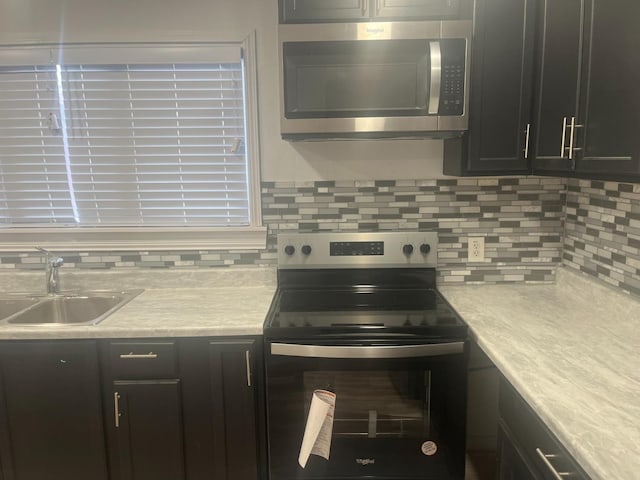 kitchen featuring tasteful backsplash, sink, and range with electric cooktop