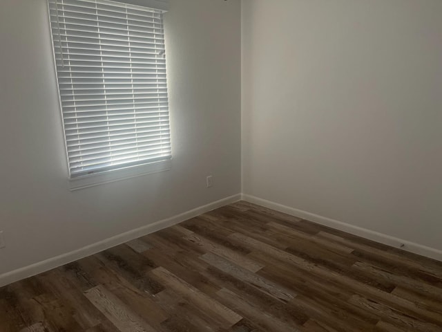 spare room featuring dark wood-type flooring