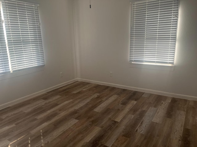 unfurnished room featuring dark hardwood / wood-style flooring