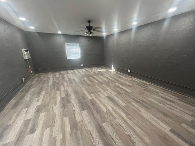 spare room with ceiling fan and light wood-type flooring