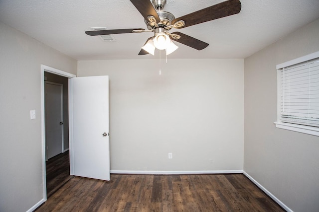 spare room with ceiling fan, dark hardwood / wood-style flooring, and a textured ceiling