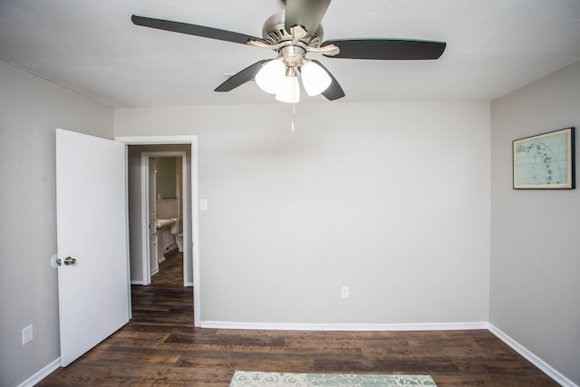 spare room featuring dark hardwood / wood-style floors and ceiling fan