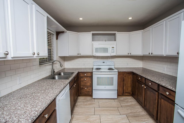 kitchen featuring tasteful backsplash, sink, white cabinets, dark brown cabinets, and white appliances