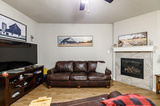 2541 137th St, Lubbock, TX 79423 - living room featuring ceiling fan, a tile fireplace, and light hardwood / wood-style flooring