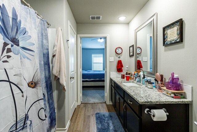 2541 137th St, Lubbock, TX 79423 - bathroom with vanity, hardwood / wood-style flooring, and walk in shower