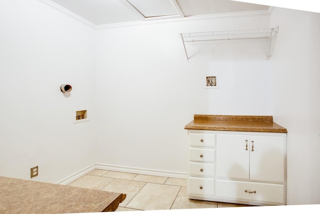 laundry area with washer hookup, ornamental molding, cabinets, and light tile patterned flooring