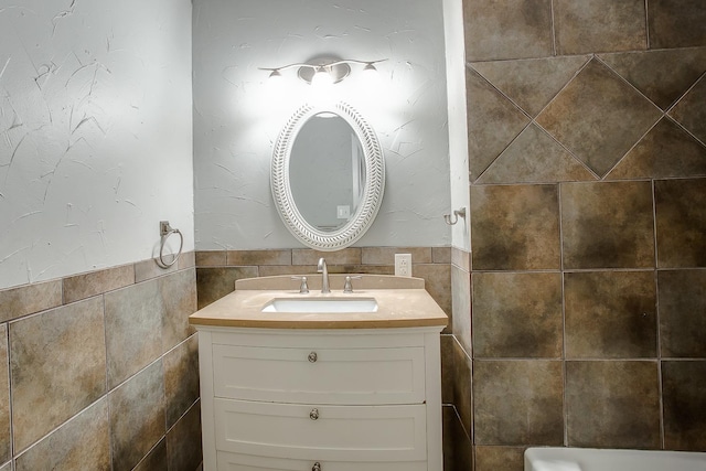 bathroom with vanity and tile walls