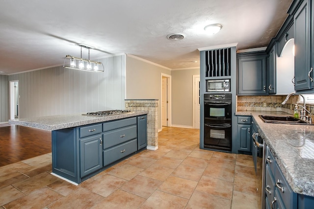 kitchen with blue cabinetry, sink, decorative light fixtures, ornamental molding, and appliances with stainless steel finishes