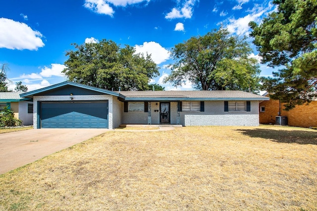 ranch-style home with central AC, a garage, and a front lawn