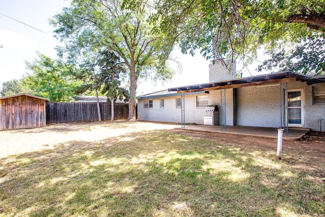 view of yard featuring a patio and a shed