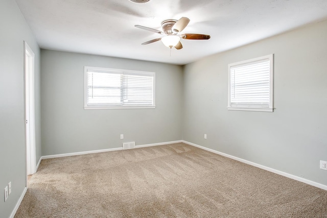 unfurnished room with carpet and ceiling fan