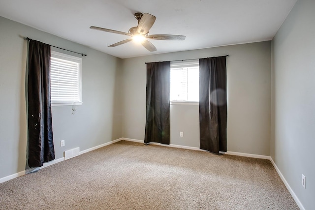 carpeted empty room with ceiling fan